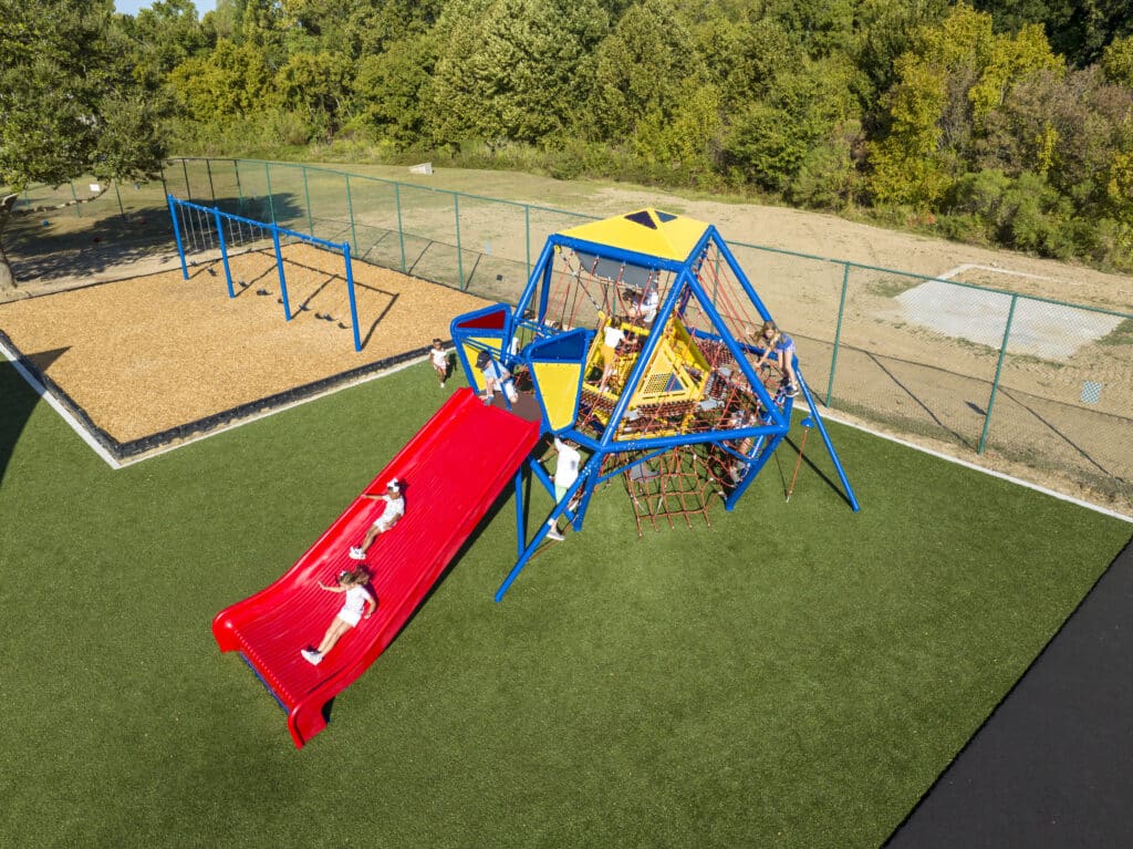 Children go down a massive slide at a playground in Baton Rouge