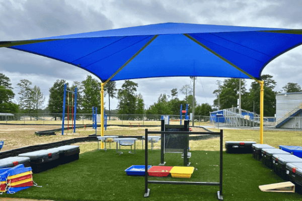 AAD Shade Structures_Blog Post (5) A blue shade structure covers an outdoor physical education classroom.